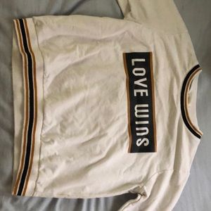 long sleeve that says “love wins”